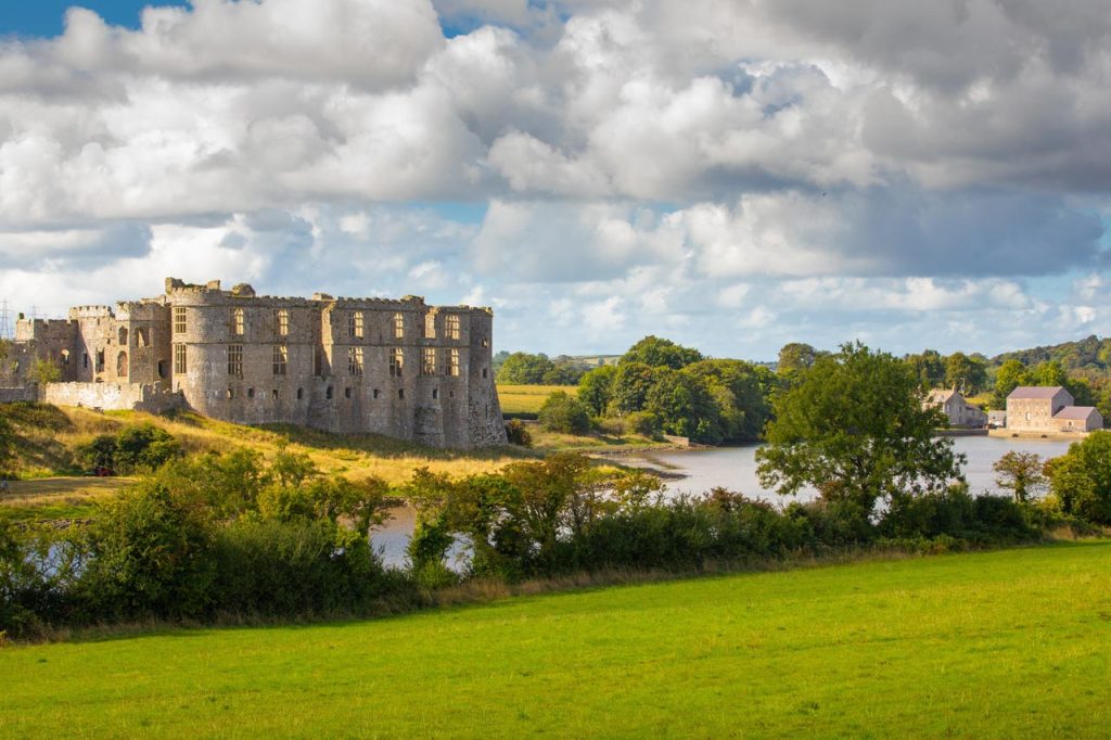 Carew Castle in Pembrokeshire beside the millpond, a striking medieval castle in the West Wales countryside