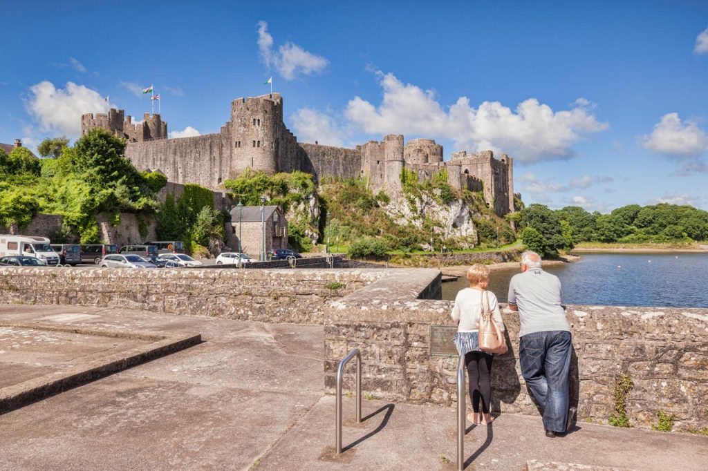 Pembroke Castle in Pembrokeshire rising above the river, one of the largest historic castles in West Wales